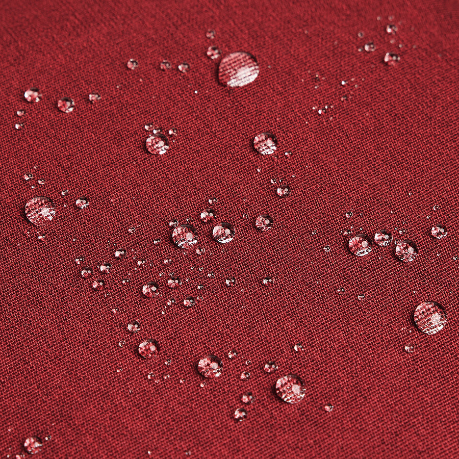 water beading off red recycled material used to construct Solo Re:cover Backpack