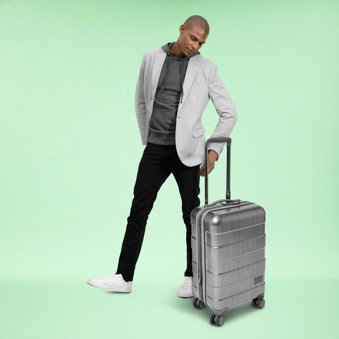 model using grey Solo Re:serve Carry-On Spinner suitcase
