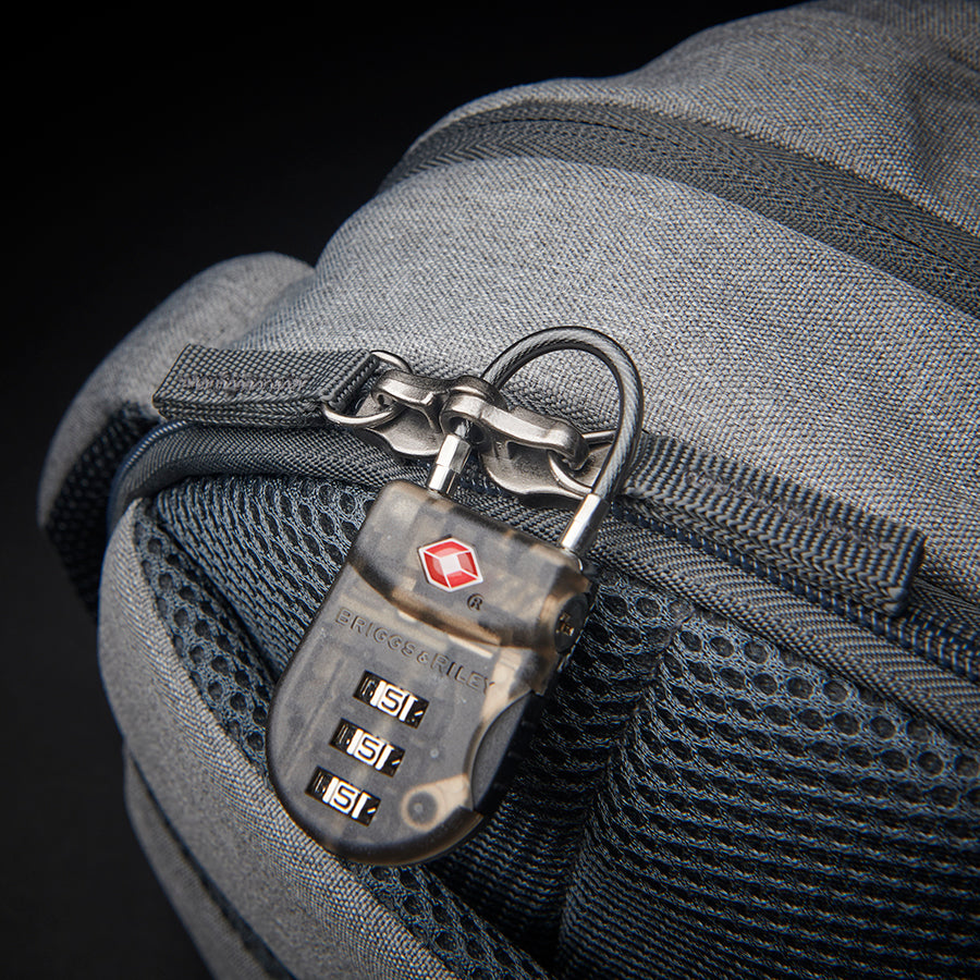 view of lock being used on back pocket on Solo Re:define backpack