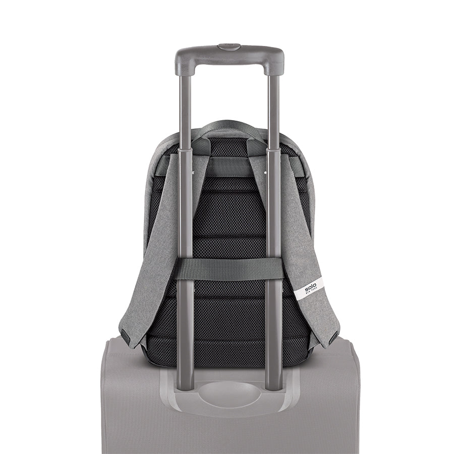 grey Solo Re:cover Backpack attached to luggage handle using back strap feature