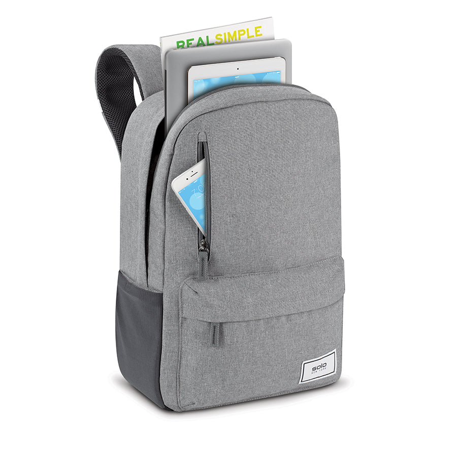 grey Solo Re:cover backpack shown with ipad, computer, iphone, and magazine