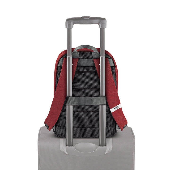 red Solo Re:cover Backpack attached to suitcase handle