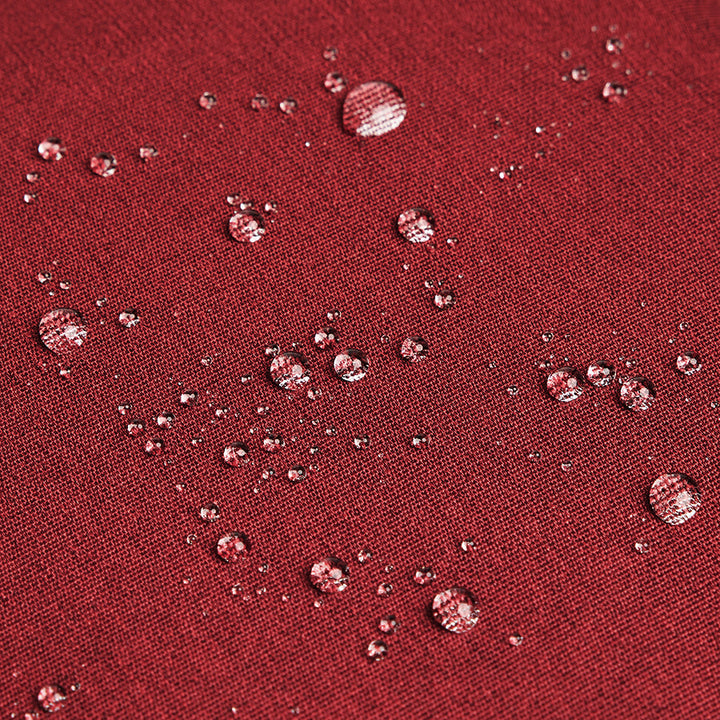 water beading off red recycled material used to construct Solo Re:cover Backpack