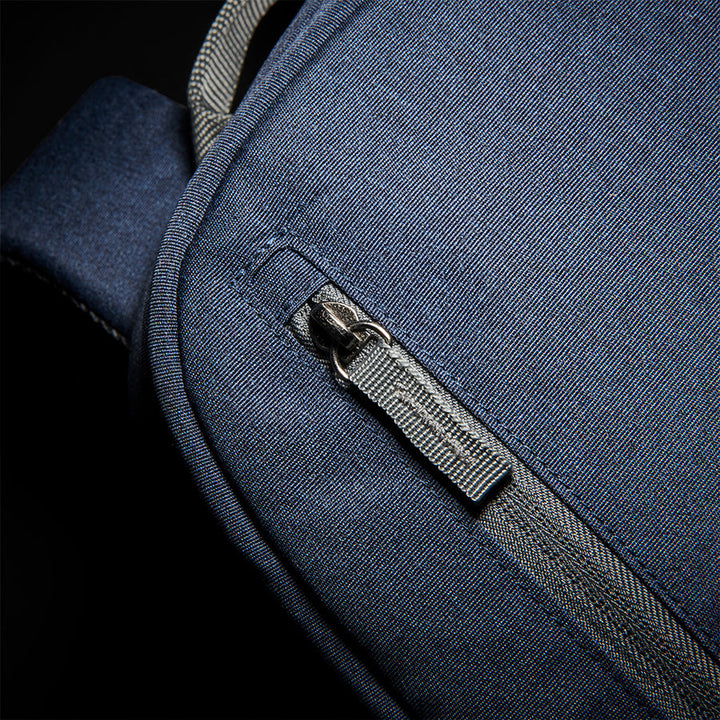 close up of zipper on front pocket of Solo Re:cover Backpack in navy