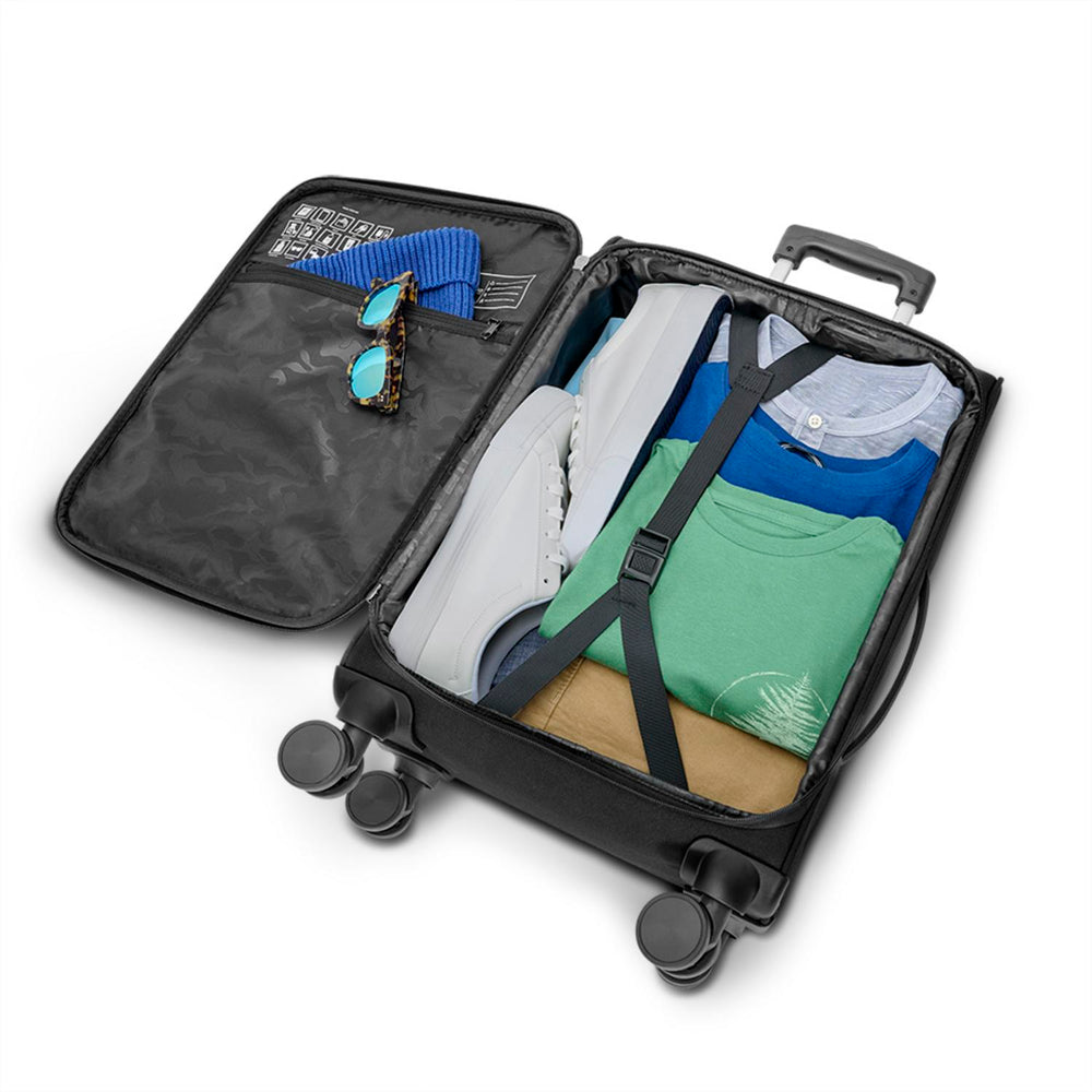 Solo Re:treat Carry-On Spinner Suitcase packed with clothing and accessories